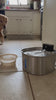 Golden retriever walks past the old bowl and drinks from the Kilde fountain